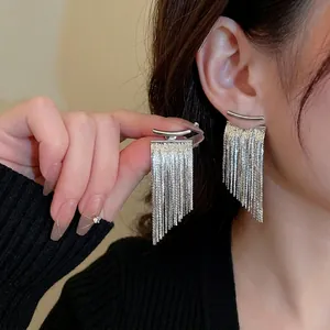 Modern silver-colored long tassel earrings featuring metal arc posts and layered chains