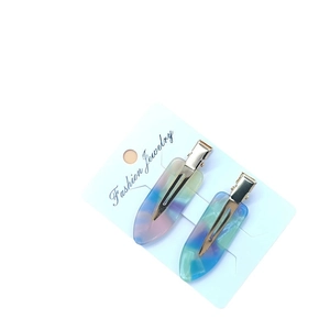 Pair of colorful gradient acetate hair clips in water drop shape on a display card