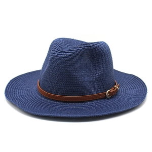 Detailed texture of navy straw fedora hat featuring a stylish brown leather buckle band