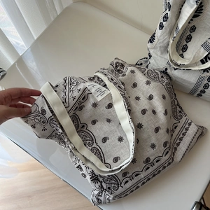 Close-up of paisley pattern and ethnic embroidery on cotton linen tote bag surface