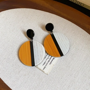 Macro detail of geometric tiger eye style resin hoop earring with 18k gold plating