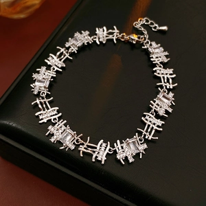 Close-up of silver zircon bracelet on black leather stand with sharp metal luster