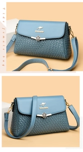 Macro detail of the woven texture and metal flower clasp on the blue crossbody bag