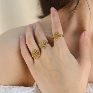 Gold tree of life, heart and star ring set with cubic zirconia on model's hand