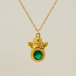 Detail of a gold angel cherub pendant holding a green faceted emerald-like stone