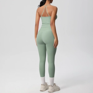 Detail of mint green yoga set featuring a cross-back strap top and high-waist leggings