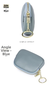 Detailed macro view of the blue litchi grain leather texture and gold zipper hardware