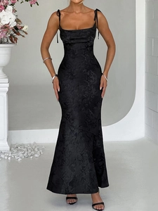 Detail of elegant black mermaid dress with subtle floral jacquard and back view slit