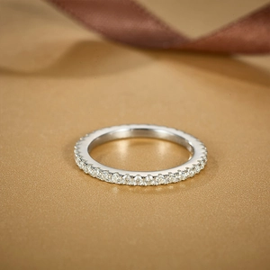 Macro shot of silver S925 eternity ring with white round-cut moissanite stones