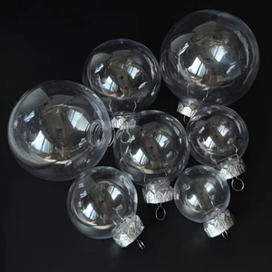 Macro view of transparent Christmas baubles with silver textured caps and metal rings