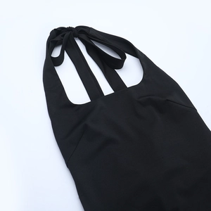 Detail shot of the halter neck tie design and knit fabric on a black jumpsuit