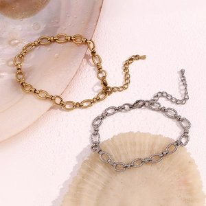 Detail of 14K gold and silver stainless steel anklets on shells with lobster clasp