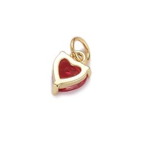 Macro shot of gold-plated heart pendant with red zircon stone for DIY jewelry