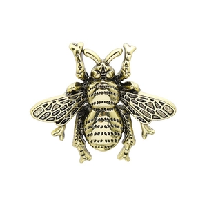 Vintage gold bee brooch with intricate engraved wing details and retro metal finish