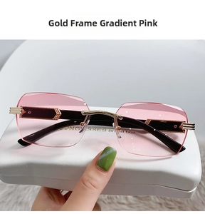 Close-up of frameless pink gradient sunglasses with gold geometric arrow temple detail
