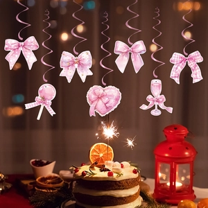 Pink bow party banner with paper decorations for a girls birthday celebration