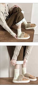 Detail of white plush socks with pink bow accent and brown fleece house slippers