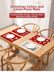 Detail of Christmas cotton linen placemats with festive prints on a wooden table