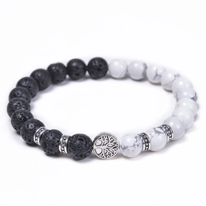 Detail of tree of life charm on tiger eye and lava stone beaded stretch bracelet