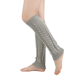 Detail of light grey knit leg warmer showing chunky cable stitch and ribbed cuff texture