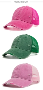 Detail of distressed mesh baseball caps in rose red, dark green, and light pink colors