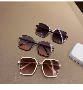 Detailed close-up of geometric half-frame sunglasses with gradient lenses in various colors