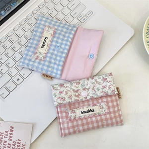 Quilted cotton menstrual pad pouches in blue and pink checkered floral fabric patterns