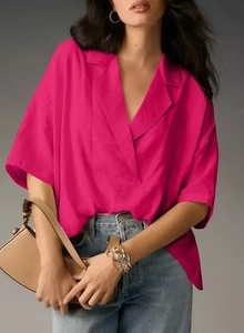Detail of rose red short sleeve shirt with V-neck lapel and silky fabric texture