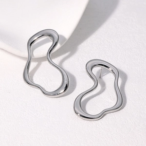 Detailed view of silver stainless steel earrings featuring an irregular curved design