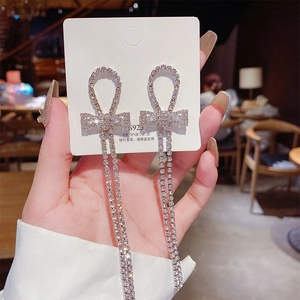 Close-up of long silver tassel earrings with micro-set rhinestones and S925 silver pins