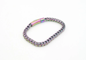 Detailed macro view of rainbow plated stainless steel Cuban link bracelet with magnetic clasp