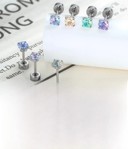 Detail of colorful gradient firework-cut zircon studs with titanium steel bases