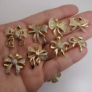 Selection of delicate gold bow pendants with micro-pave zircons for women necklaces