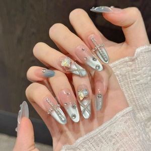 Blue cat eye press-on nails with silver chain, heart crystals and metallic cross charms