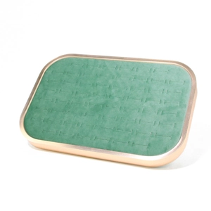 Detailed view of green microfiber jewelry tray with golden metal frame for rings