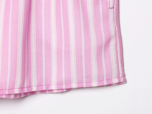 Close-up of pink and white striped shirt fabric with high-quality hem stitching detail