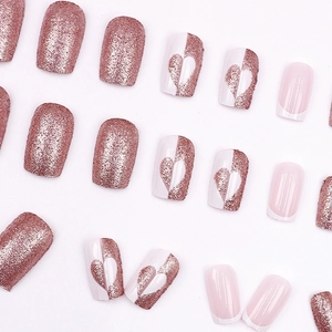 Sparkly rose gold and heart pattern press-on nails set on white background