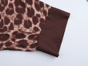 Detail shot of leopard print sleeve cuff and dark brown polyester fabric stitching