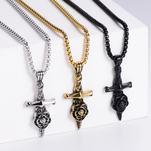 Detailed view of Gothic sword and rose pendants in silver, gold, and black stainless steel