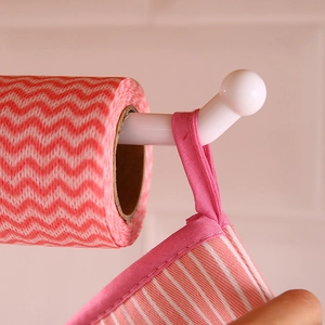 White punch-free kitchen paper towel holder storing dishtowels and oven mitts