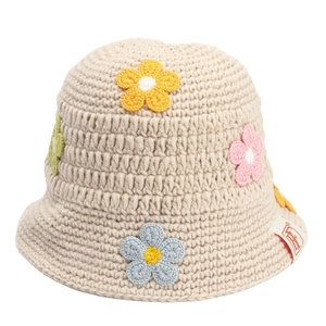 Handmade crochet bucket hat with colorful flower patterns on soft beige knit fabric