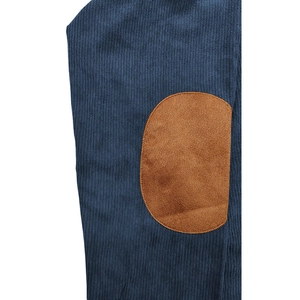 Close-up of navy blue long sleeve polo shirt showing brown faux suede elbow patches