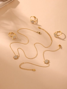 Detailed set of gold stainless steel sun jewelry with sparkling crystal embellishments