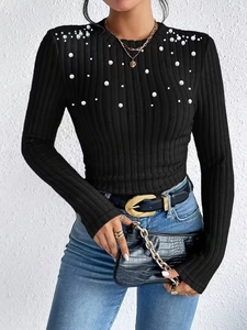 Elegant black ribbed knit top for women with pearl embellishments on chest and shoulders
