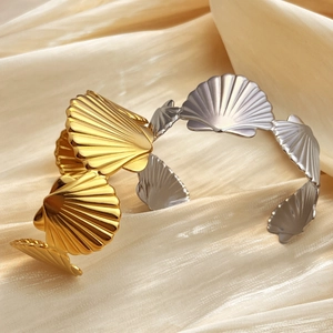 Retro 18k gold and silver stainless steel scallop shell open bangles on silk fabric