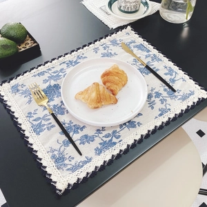 Detailed view of floral cotton linen placemat with lace trim and wavy edge decor