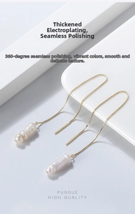 Close-up of S925 silver long gold chain earrings featuring natural baroque pearls