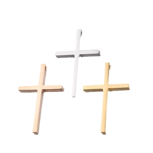 Polished stainless steel cross pendants in gold, silver, and rose gold on white background