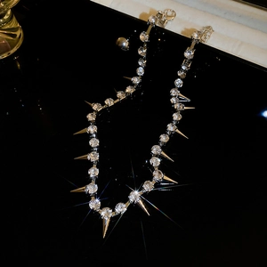 Detail of silver-toned punk choker necklace with sparkling rhinestones and sharp spikes