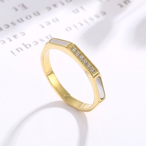 Detail of gold octagon ring with micro-set diamonds and white shell inlay accents